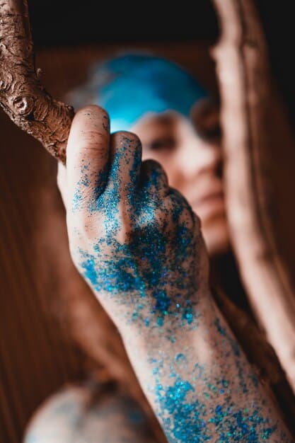 A detailed shot of a cosplayer's arm covered in meticulously applied Jinx tattoos. The tattoos are a mix of black and blue designs, including cloud-like shapes, stylized numbers, and abstract patterns. The cosplayer's skin is clean and the tattoos look crisp and well-defined.