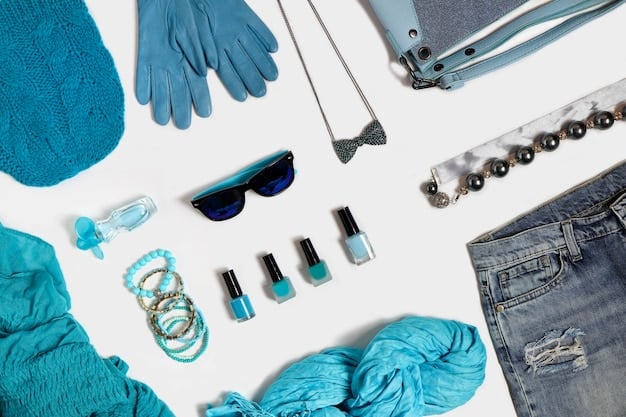 A close-up shot of various clothing items laid out on a table: a distressed blue jacket with patches, olive-green pants with visible stitching, and a gray, tattered undershirt. The items are arranged to show their worn texture and DIY modifications.
