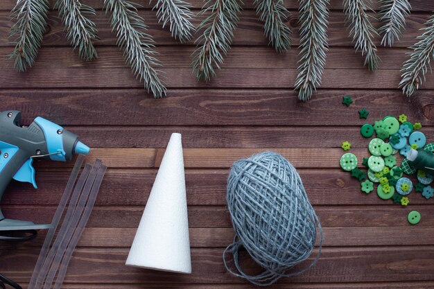 A close-up shot of various crafting materials laid out on a workbench, including EVA foam sheets of different thicknesses, acrylic sheets, LED strip lights, wiring, soldering iron, and various hand tools.