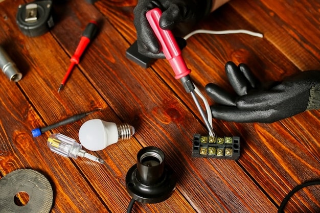 A detailed workbench with tools, wires, and LED components used to install the lighting into the gauntlets. The gauntlets are partially assembled, showing the wiring and placement of the LEDs within the structure.