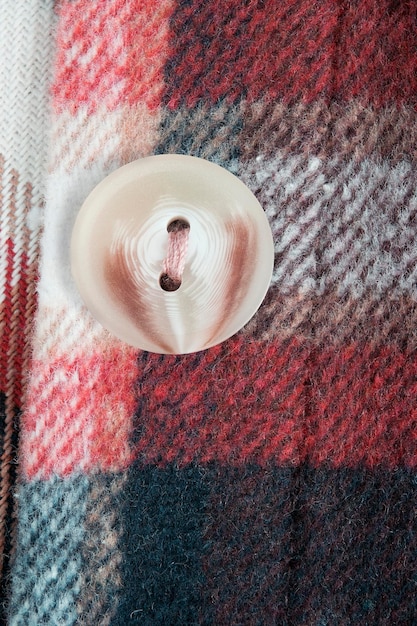A detailed shot of the fabric and stitching on a Deckard-style trench coat, highlighting the texture and tailoring. The image shows details like the seams, buttons, and belt loops, with a soft, diffused lighting.