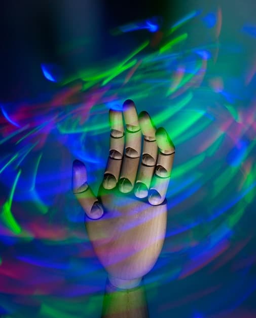 A stylized, abstract image depicting a reviewer's hands playing an indie game on a PC, with the screen glowing with unique art styles and vibrant colors, symbolizing discovery.
