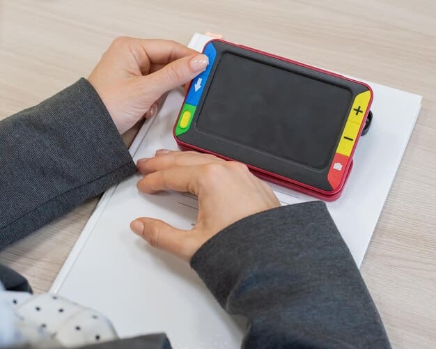 A close-up of a hand holding a gamepad, with a notebook and pen nearby, suggesting the interplay between gaming and critical assessment.