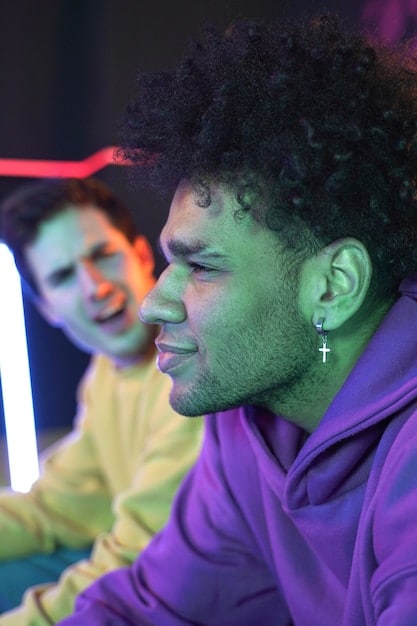 A close-up of a streamer's face showing intense focus and excitement while playing a challenging PC game, with a vibrant gaming setup in the background, illustrating deep player engagement.