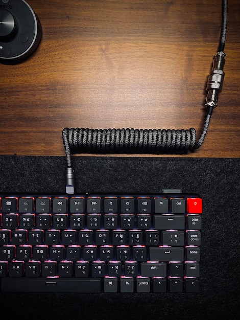 A detailed shot of high-performance gaming equipment, including a mechanical keyboard, high-refresh-rate monitor, and ergonomic gaming chair, set up in a modern competitive environment.