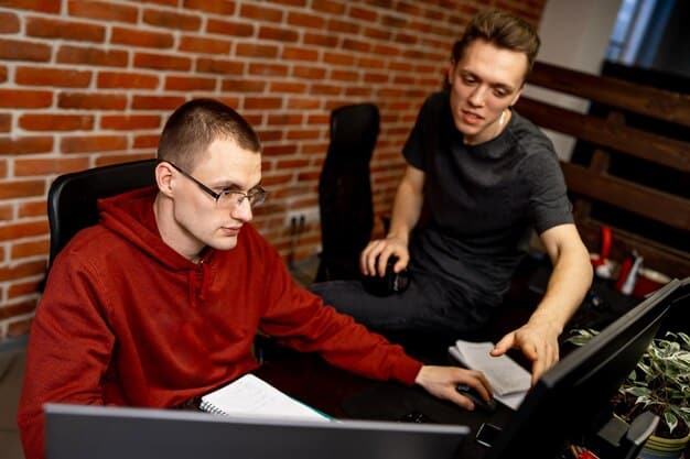 A collegiate esports coach intently reviewing game footage on a large monitor with a student athlete, highlighting strategic points and providing feedback. Shows coaching and analysis.