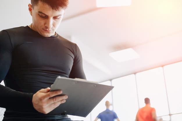 A close-up shot of a coach analyzing player statistics on a tablet during a timeout in an esports tournament. The tablet screen displays various charts and graphs illustrating player performance metrics. The coach's expression is thoughtful and focused, emphasizing the importance of data analysis in real-time decision-making to Level Up Your Game: How US Esports Teams Are Using Data Analytics to Gain a 15% Win Rate Advantage in 2025.